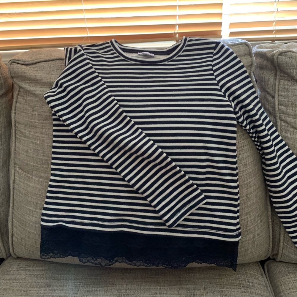 Mexx kids stripped sweather with a lace detail at the bottom.